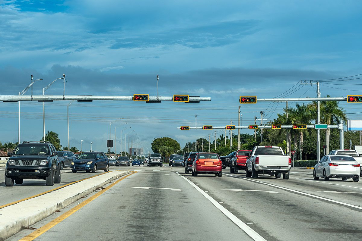 Traffic stopped by the traffic light at a Miami intersection.