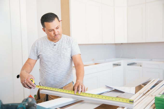 Using a measuring tape for kitchen installation