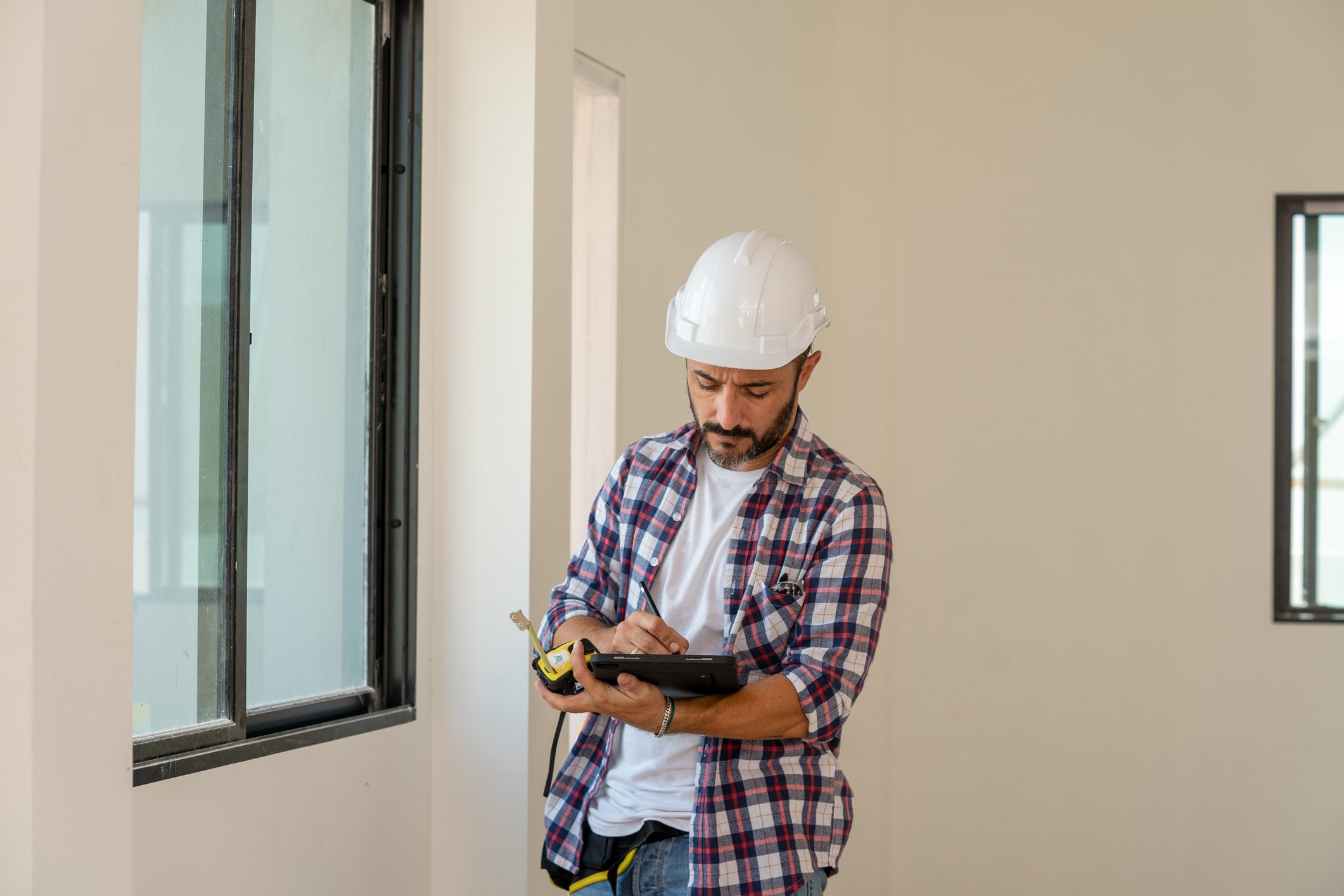 Construction inspector checking new house.