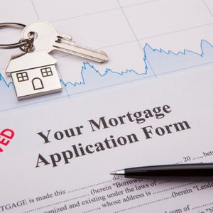 An empty mortgage application form with house key