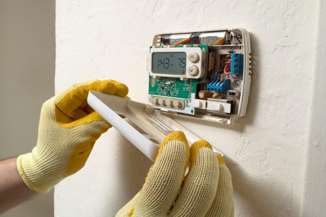 Air conditioning repair man performing maintenance