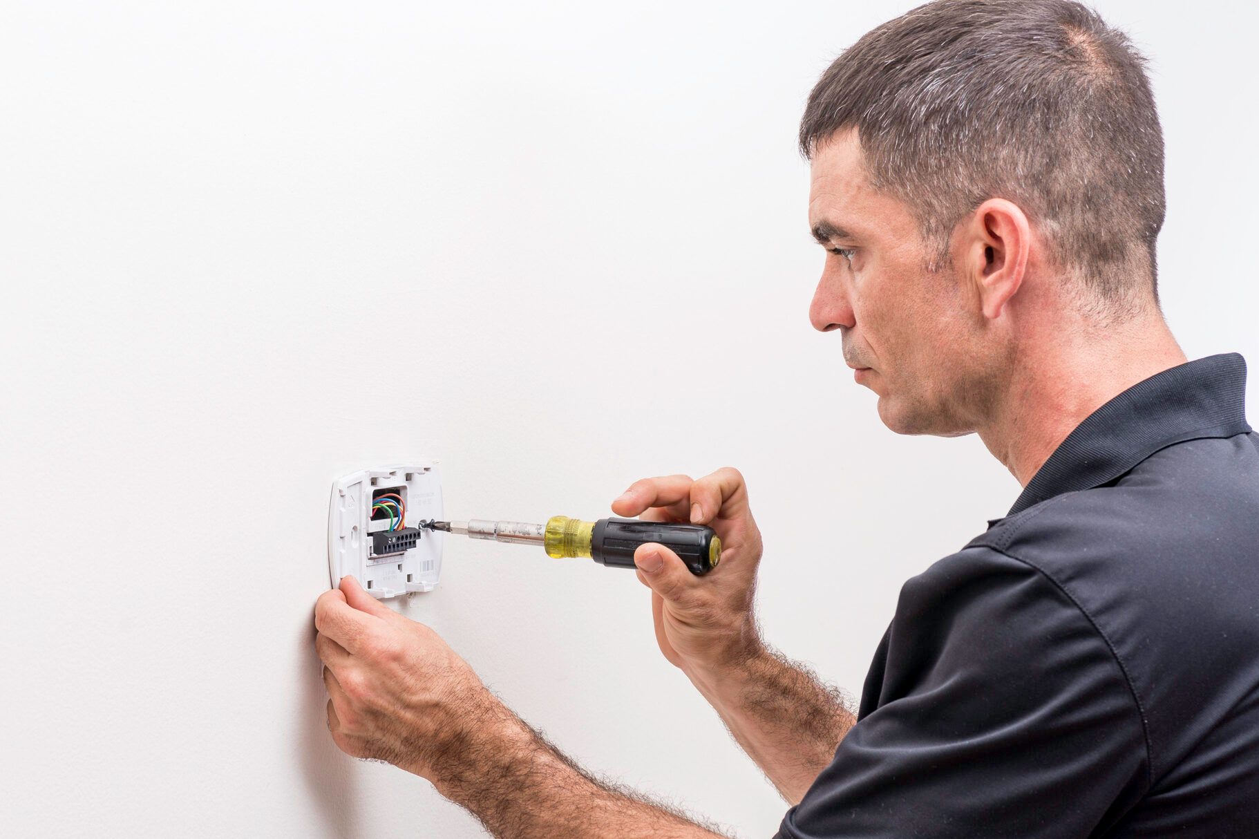 Hvac Tech Installing Thermostat