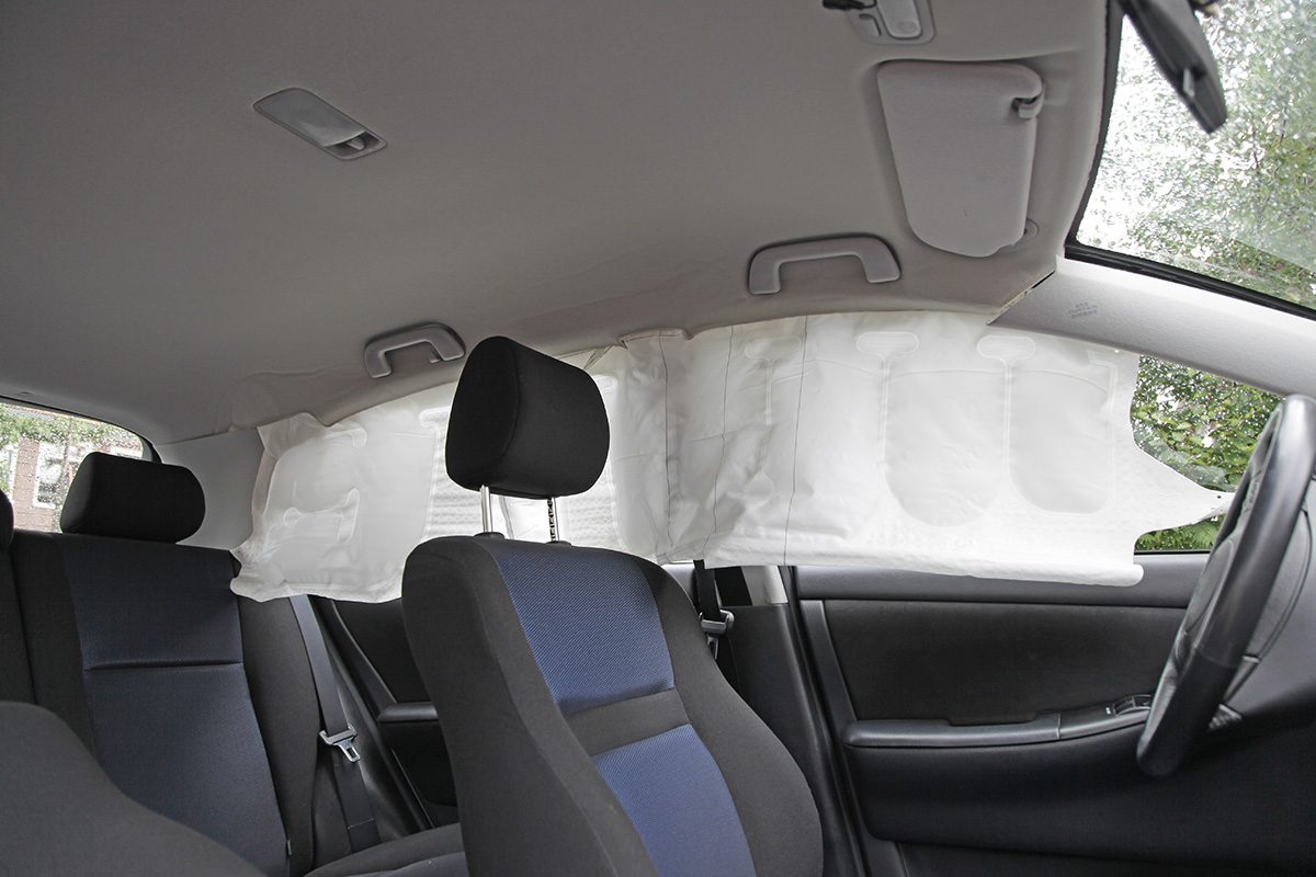Car interior with fully deployed side airbags (or curtain airbags) after accident