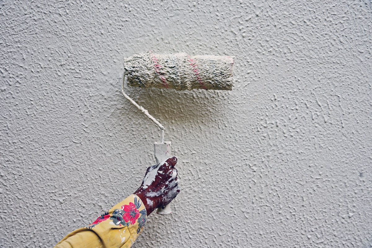 painting wall with paint roller
