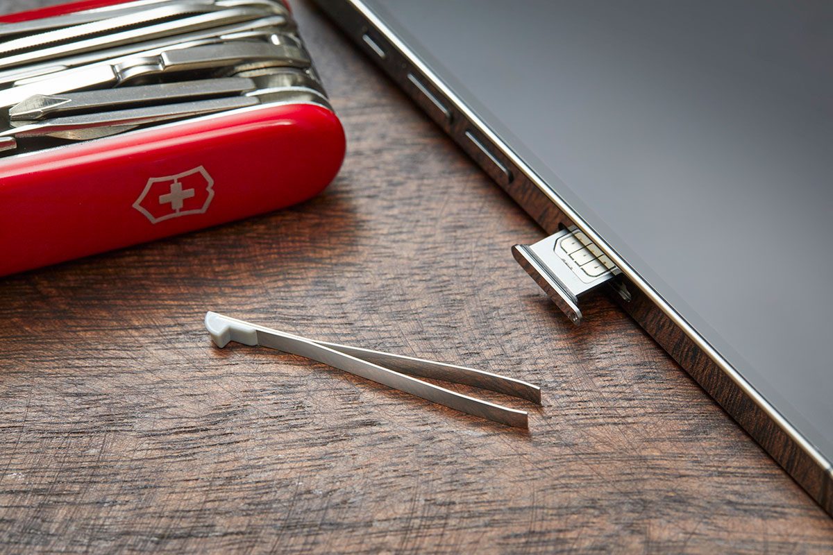 Closeup of a cell phone and a swiss army knife