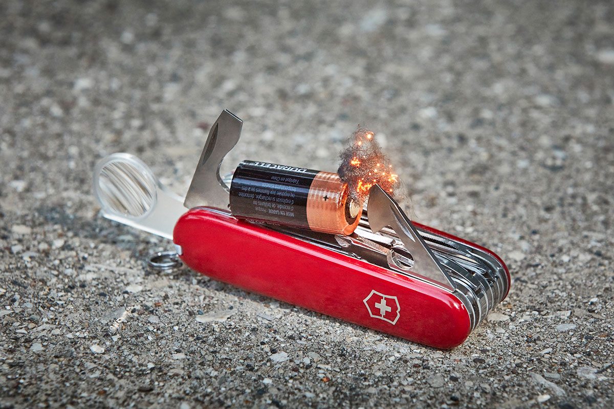 A battery attched to a swiss army knife to start a fire