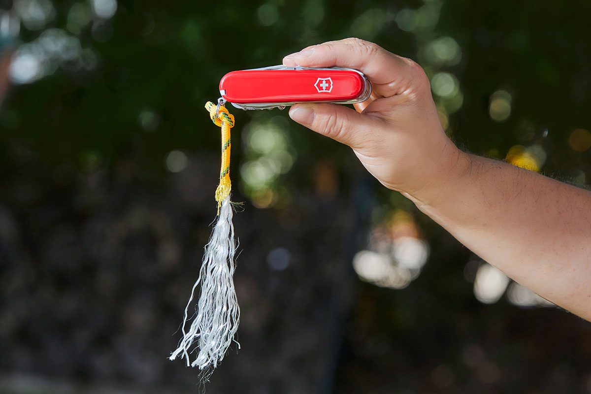 A hand holding a swiss army knife