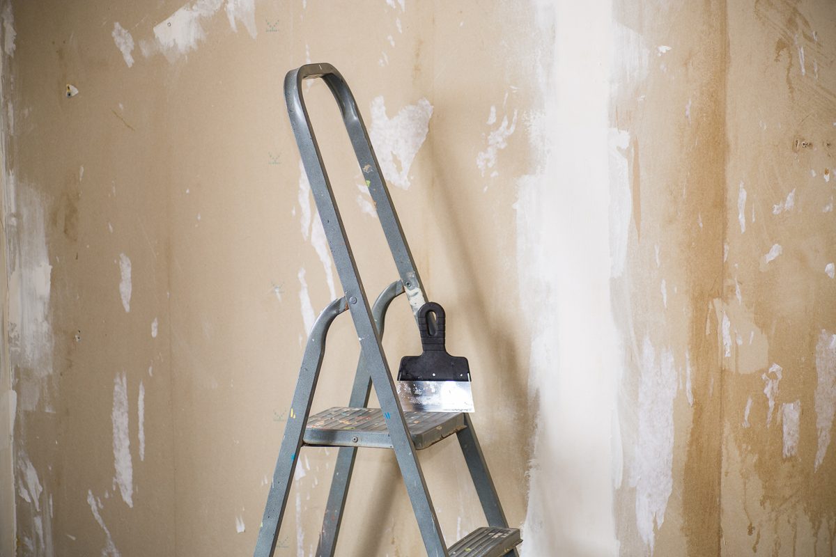 stepladder on the background of plastered walls before renovation