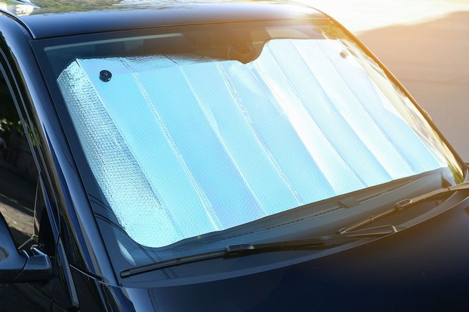 un shade under windshield inside car, closeup. Heat protection