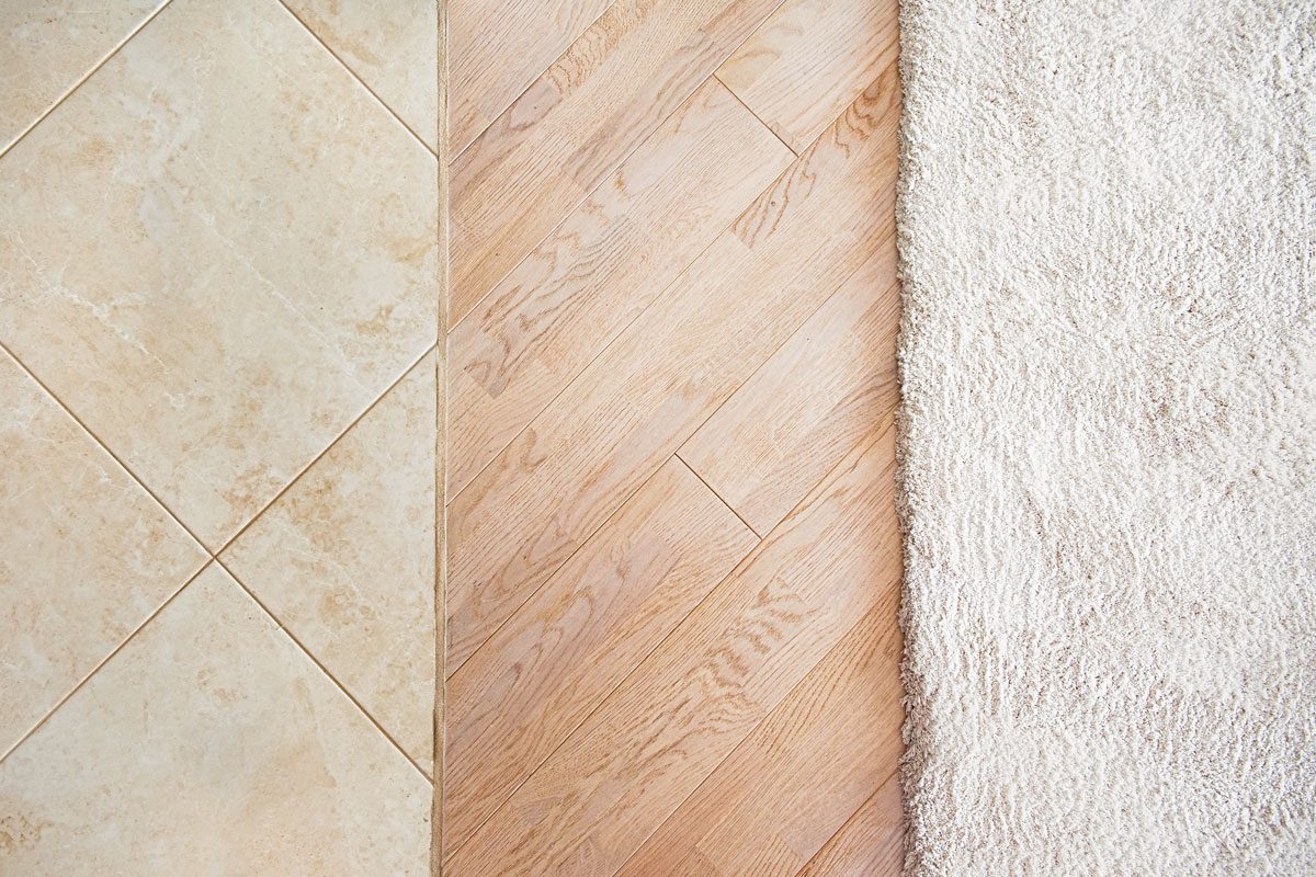 Floor With Marble Tile Pattern Laminate Parquete Floor With Beige Soft Carpet Gettyimages 683705298 Ksedit