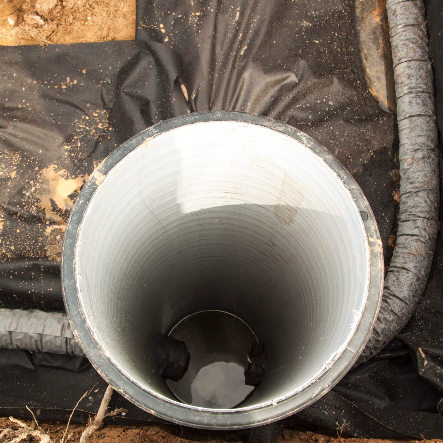 close up top view of drainage pipes and inspection well for remo