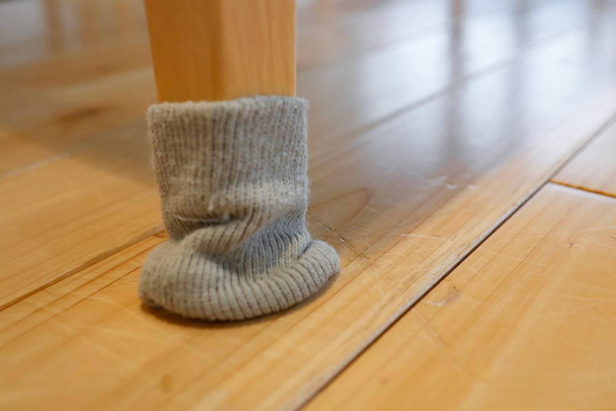furniture leg covered with cloth to avoid scratching floor