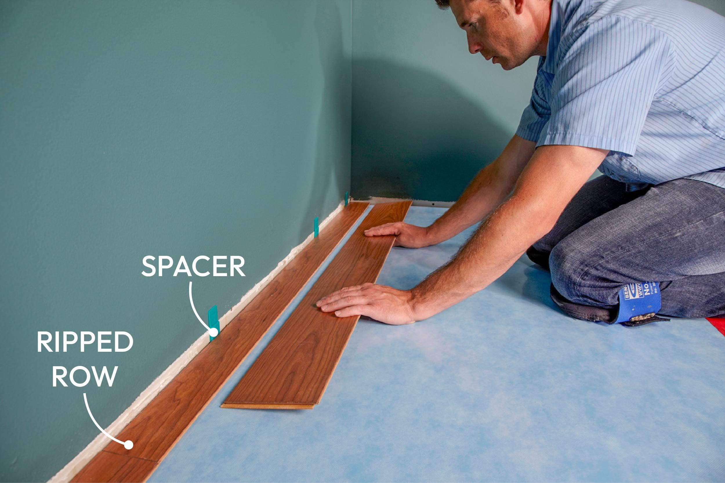 man installing laminate wood flooring
