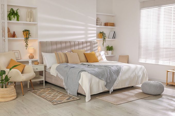 Comfortable large bed in beautiful room. Interior design