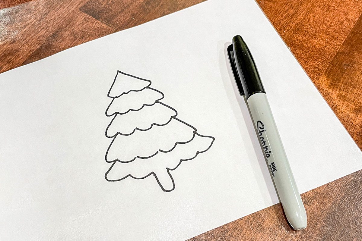 drawing of a tree on a white sheet of paper and a marker