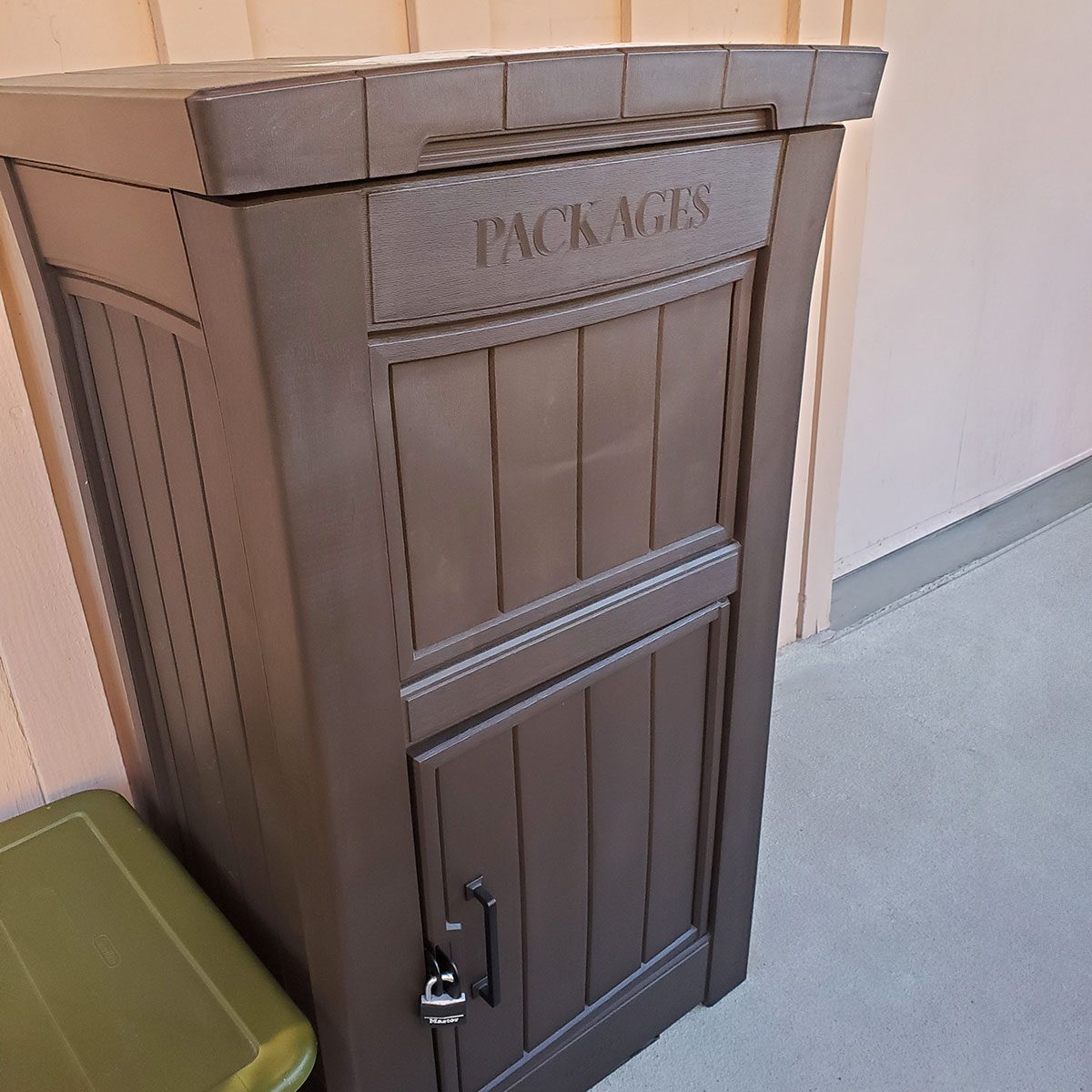 High-angle close-up of a padlocked package delivery box