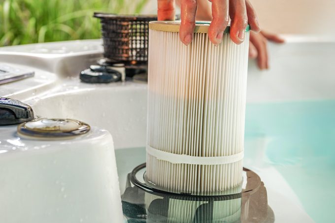 close up of man replacing hot tub filter