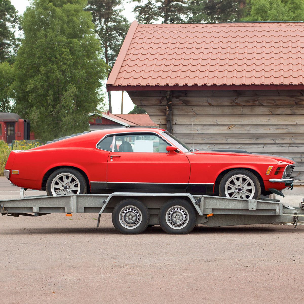 red car on a flatbed trailer