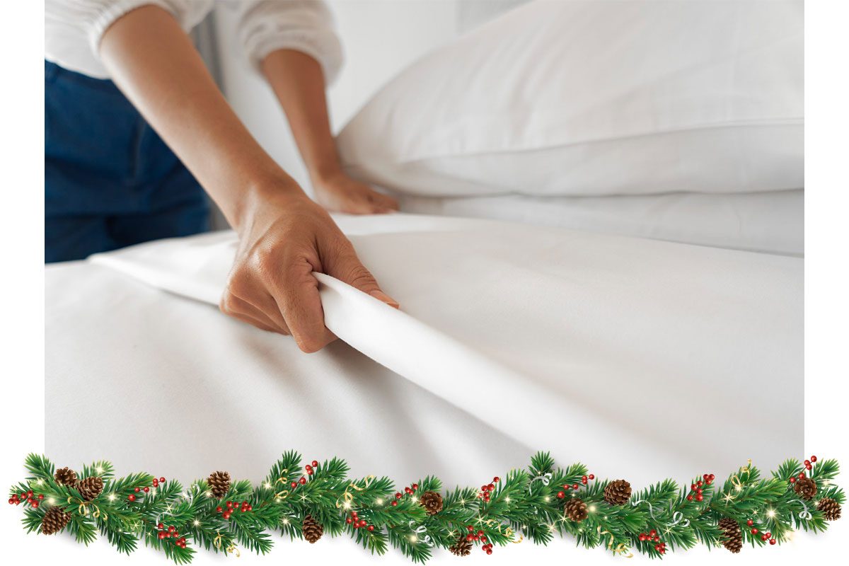 Female Hand set up white bed sheet in bedroom